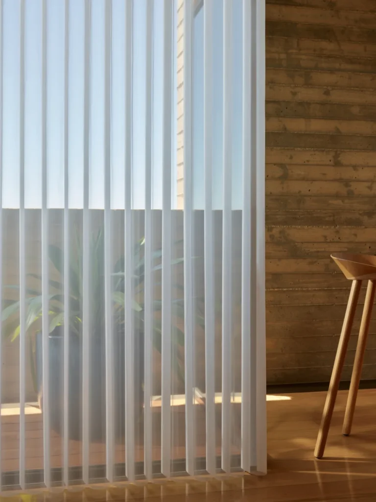 Hunter Douglas Luminette Privacy Sheers with rotating vertical fabric vanes on a patio door